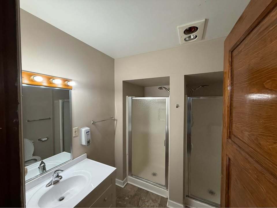220 College Avenue, Unit 2 DeKalb, IL 60115 - Photo 8 of 14 a bathroom with a sink and mirror