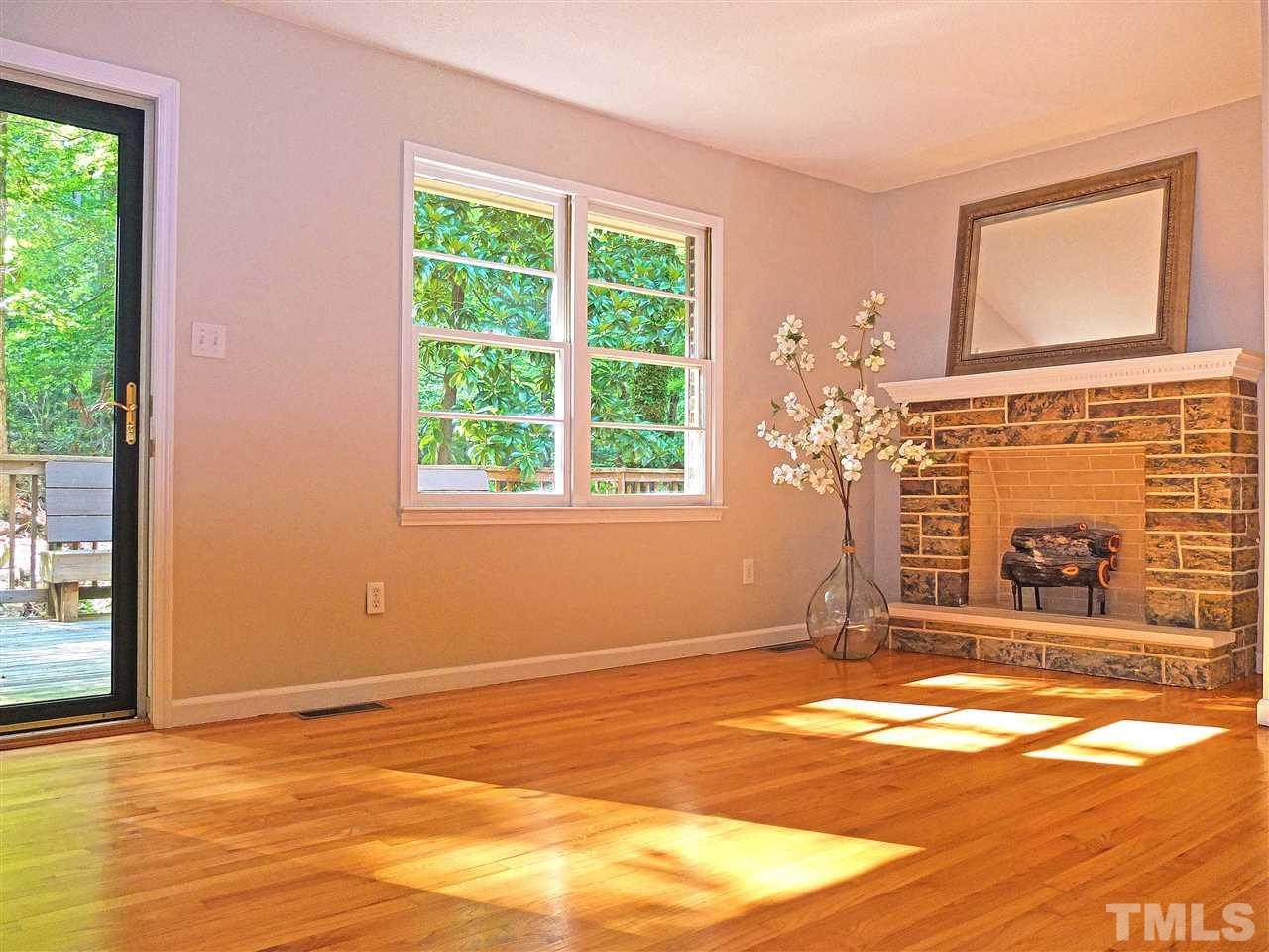 6808 Laurdane Road Raleigh, NC 27613 - Photo 2 of 25 a view of empty room with a fireplace and floor to ceiling window