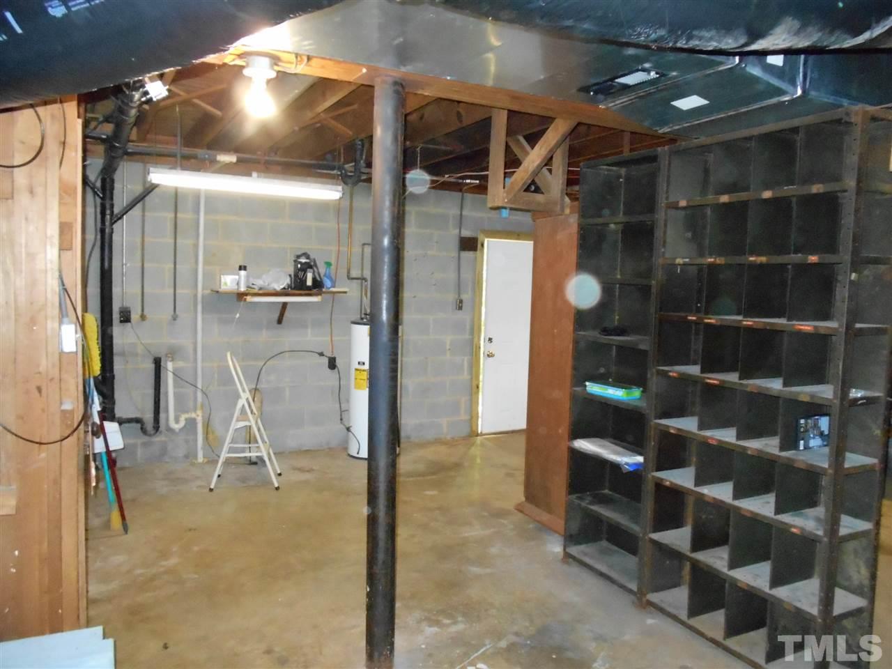 6808 Laurdane Road Raleigh, NC 27613 - Photo 16 of 25 a view of a room with shelves