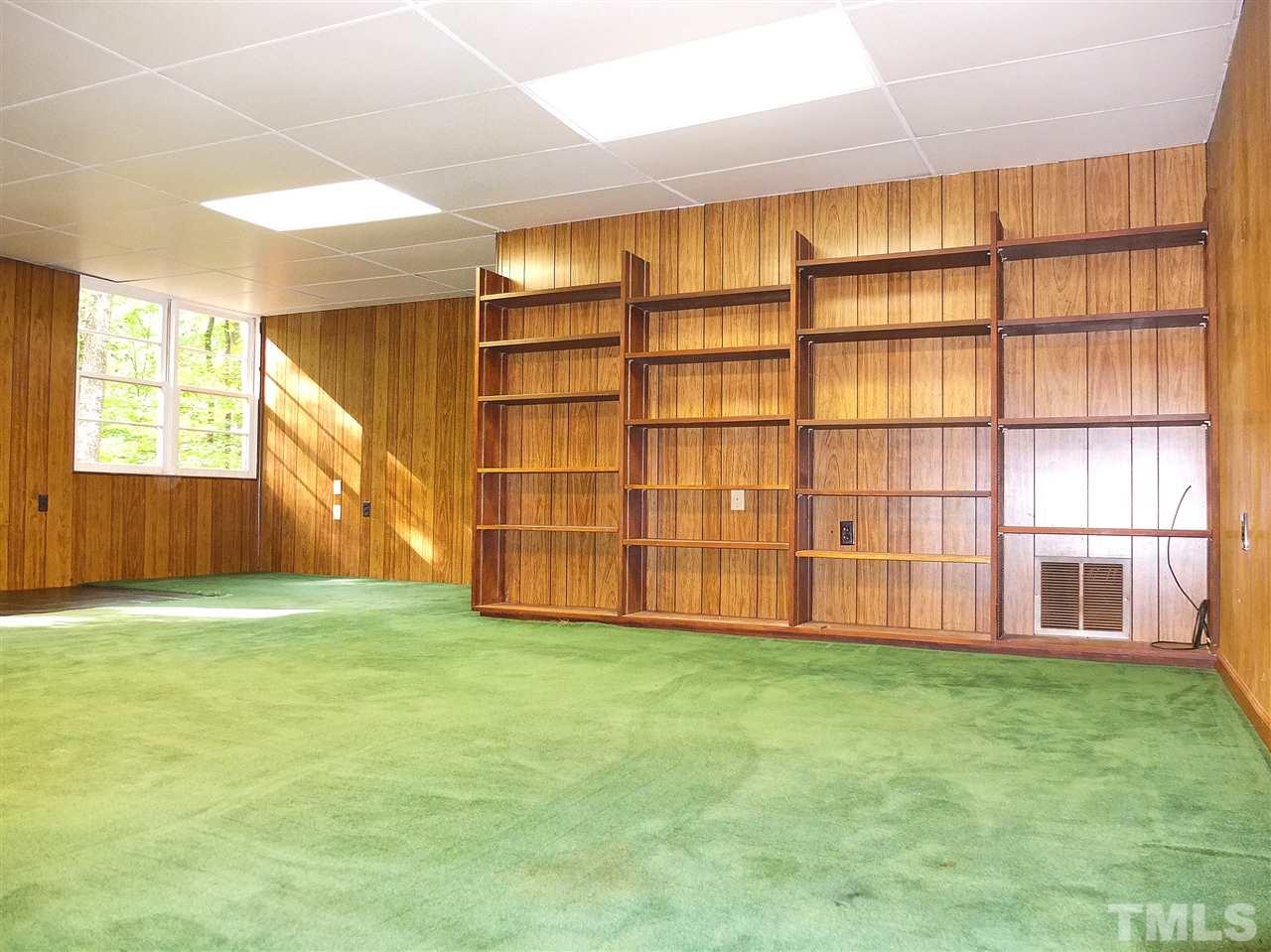 6808 Laurdane Road Raleigh, NC 27613 - Photo 10 of 25 a view of an empty room with a window and brick walls