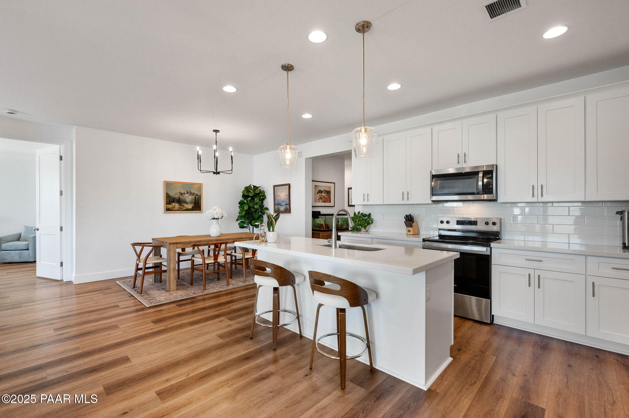 5902 Finch Place Prescott Valley, AZ 86314 - Photo 14 of 116 a kitchen with a table chairs refrigerator and cabinets
