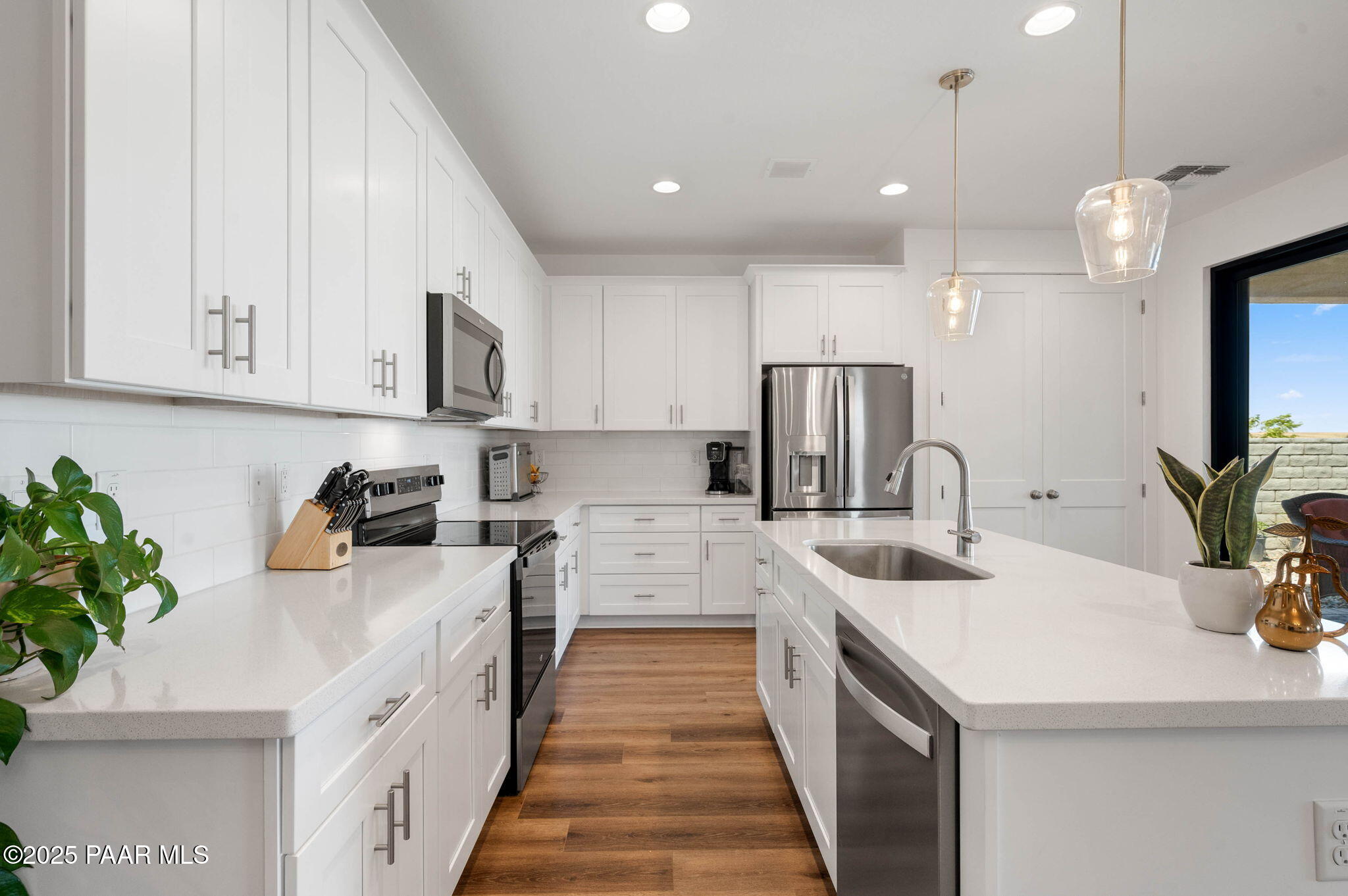5902 Finch Place Prescott Valley, AZ 86314 - Photo 16 of 116 a kitchen with stainless steel appliances a sink a stove top oven a counter space and cabinets