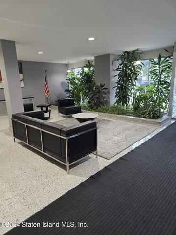 a room with furniture and potted plants