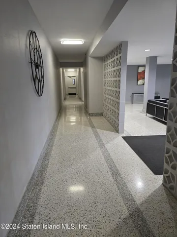 a view of a hallway with wooden floor and workspace