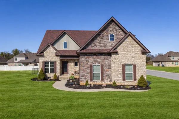 a front view of a house with a yard table and chairs