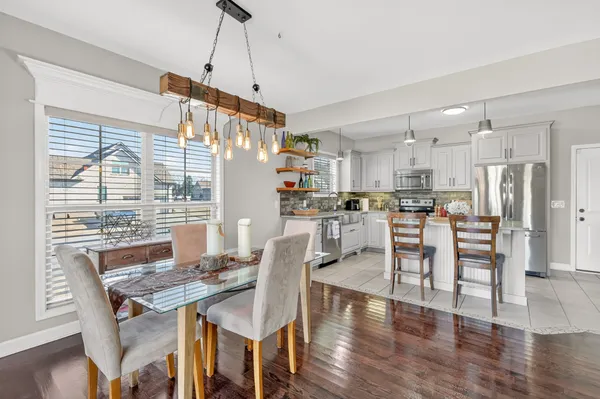 a view of a dining room with furniture window and wooden floor