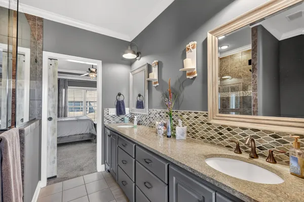 a spacious bathroom with a sink double vanity and a mirror