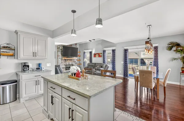 a open kitchen with stainless steel appliances granite countertop a stove and a wooden floor