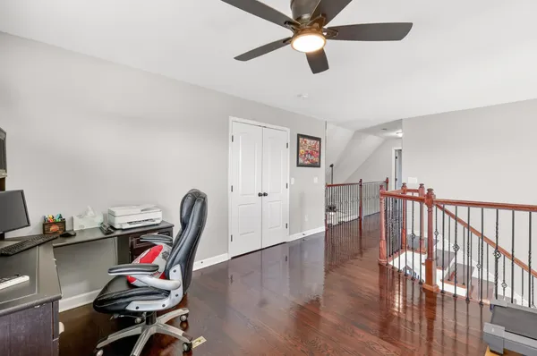 a view of a workspace with furniture and gym equipment