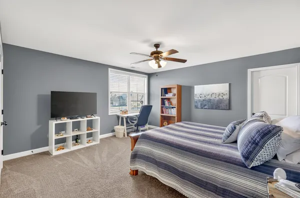 a bedroom with furniture and a flat screen tv