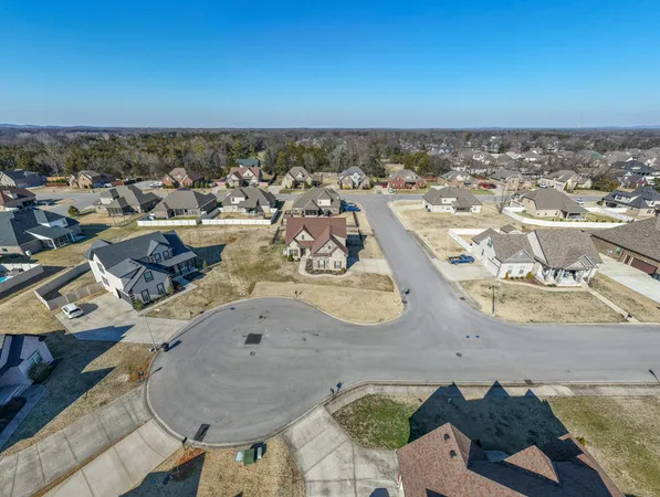 an aerial view of a house with wooden floor and city view