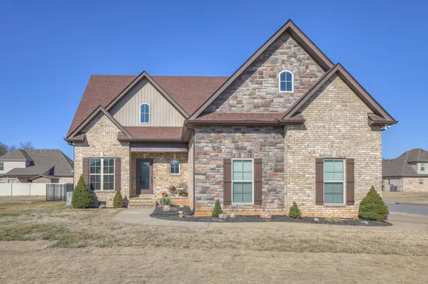 a front view of a house with a yard