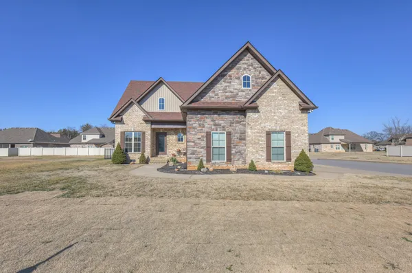 a front view of a house with a yard and garage