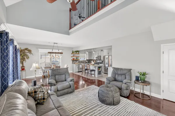 a living room with furniture and wooden floor