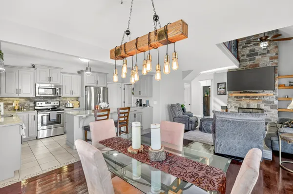 a kitchen with stainless steel appliances kitchen island granite countertop a refrigerator and stove