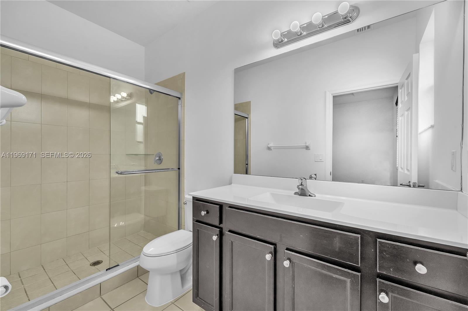 11563 Southwest 248th Lane Homestead, FL 33032 - Photo 17 of 28 a bathroom with a sink a toilet and shower