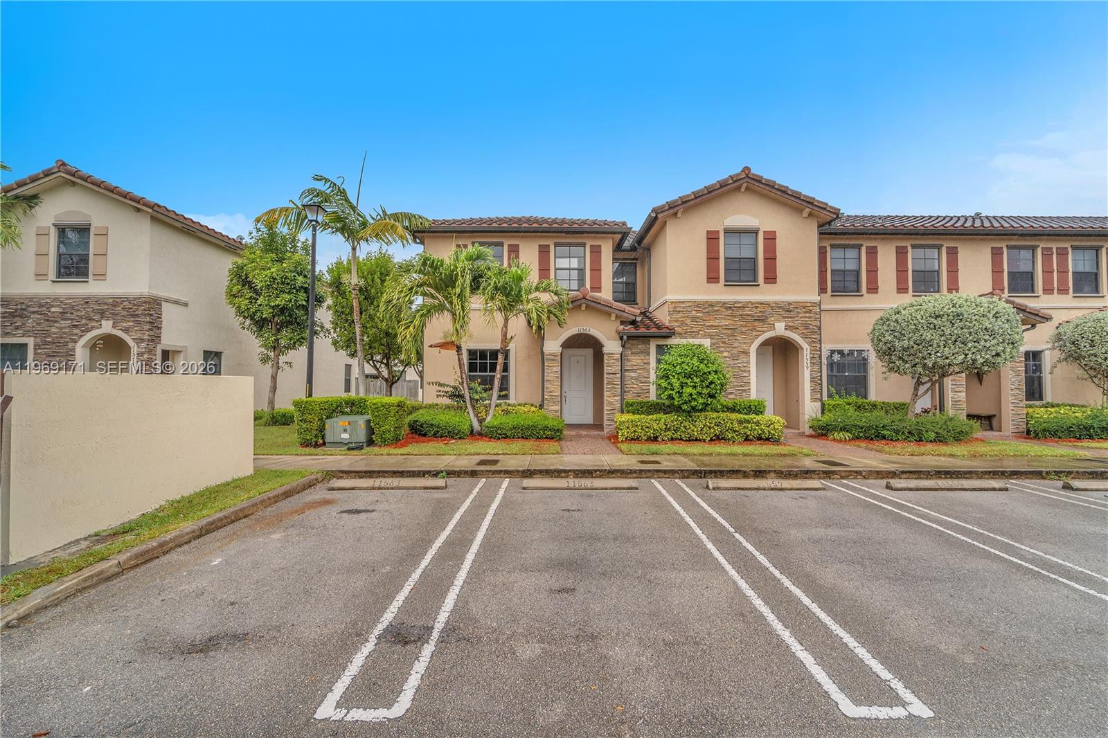 11563 Southwest 248th Lane Homestead, FL 33032 - Photo 27 of 28 a front view of a house with a yard and garage