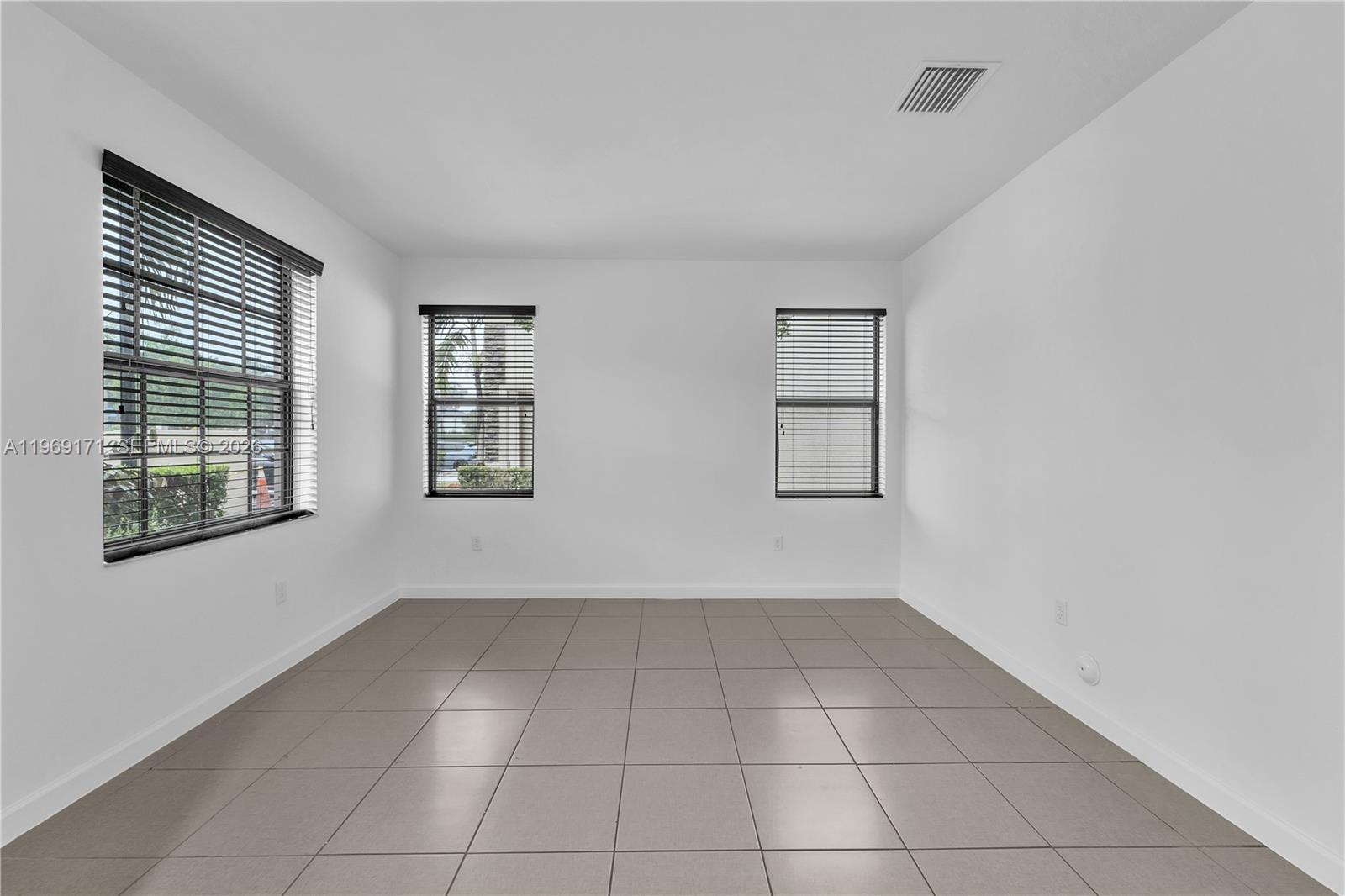 11563 Southwest 248th Lane Homestead, FL 33032 - Photo 4 of 28 an empty room with windows