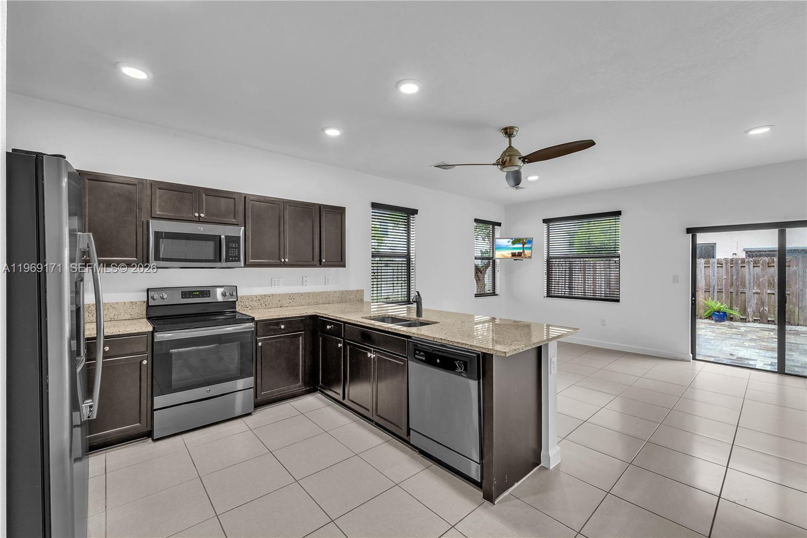 11563 Southwest 248th Lane Homestead, FL 33032 - Photo 6 of 28 a kitchen with stainless steel appliances granite countertop a stove and a sink