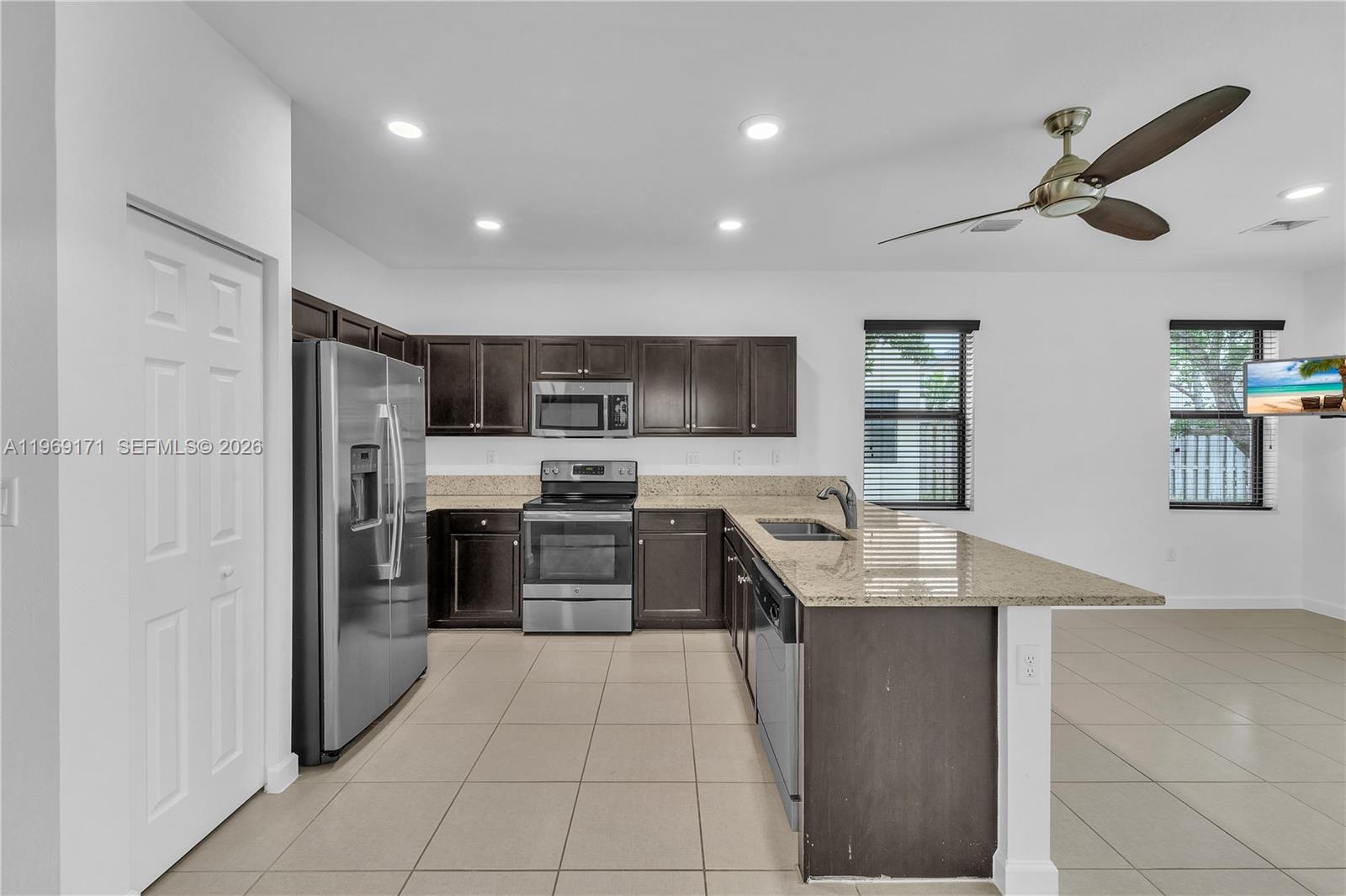 11563 Southwest 248th Lane Homestead, FL 33032 - Photo 7 of 28 a kitchen with stainless steel appliances granite countertop a refrigerator and a sink