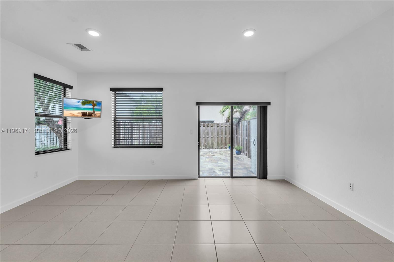 11563 Southwest 248th Lane Homestead, FL 33032 - Photo 9 of 28 a view of an empty room with glass door