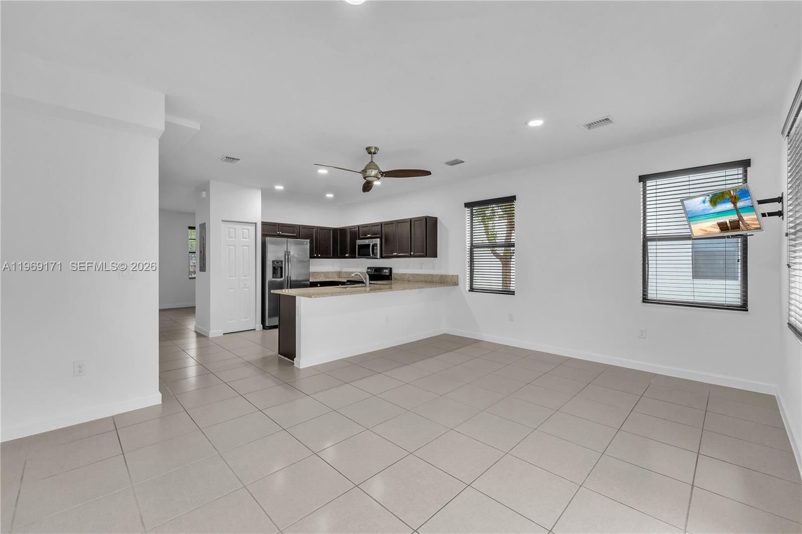 11563 Southwest 248th Lane Homestead, FL 33032 - Photo 10 of 28 a view of kitchen with white cabinets and refrigerator
