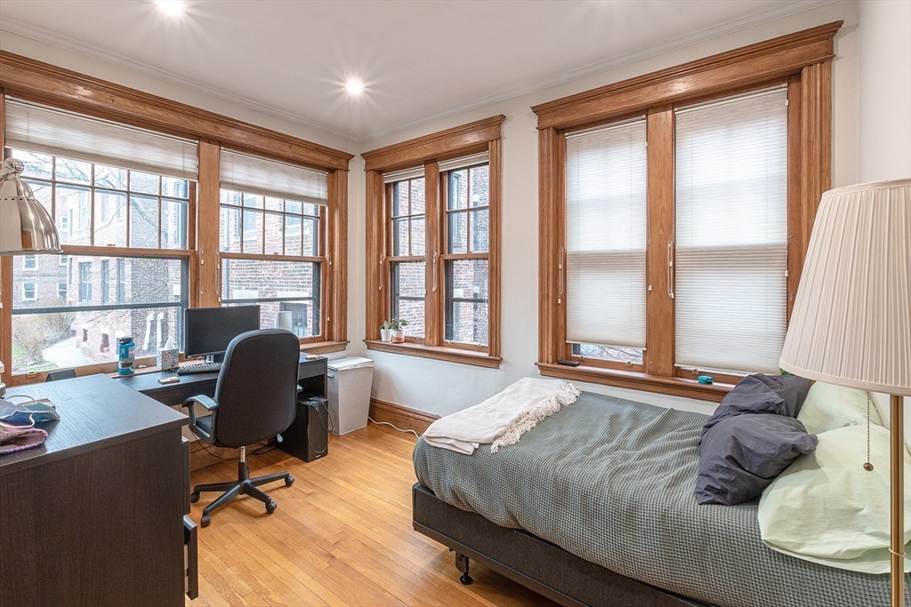 50 St Paul Street, Unit 4 Brookline, MA 02446 - Photo 11 of 21 a bedroom with a bed chair and a large window