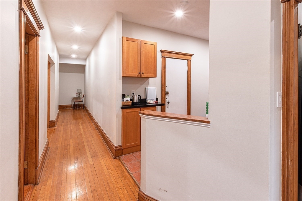 50 St Paul Street, Unit 4 Brookline, MA 02446 - Photo 15 of 21 a view of a hallway with wooden floor and a bathroom