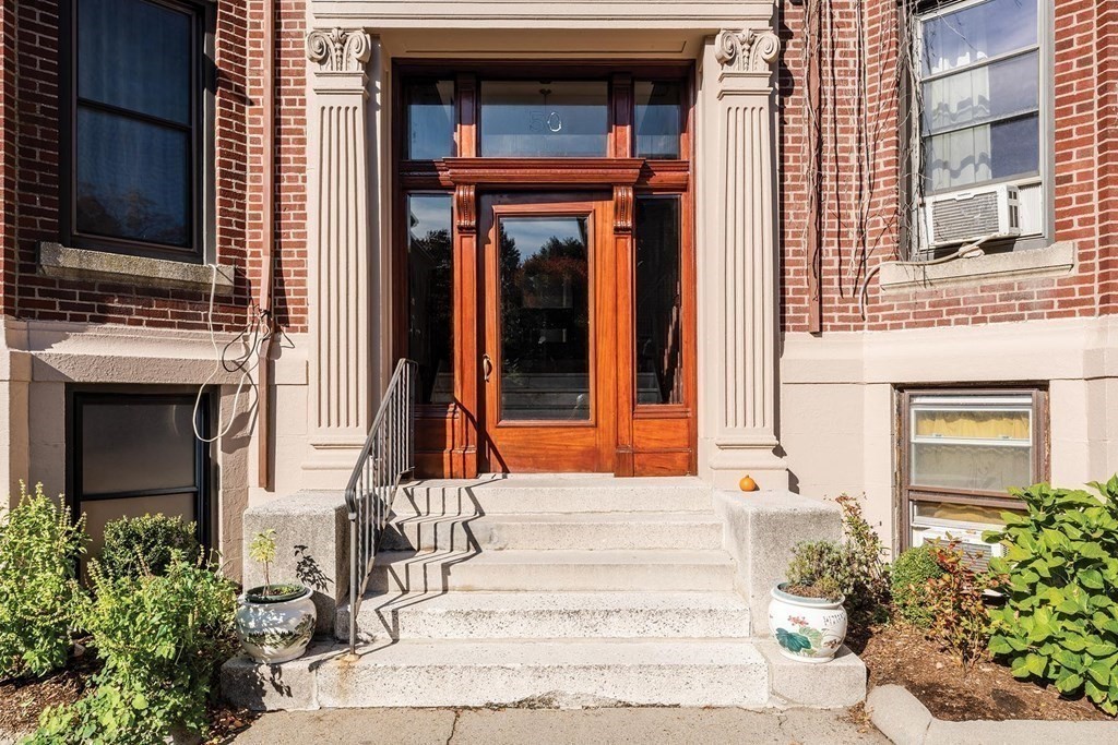 50 St Paul Street, Unit 4 Brookline, MA 02446 - Photo 19 of 21 a front view of a house with a yard