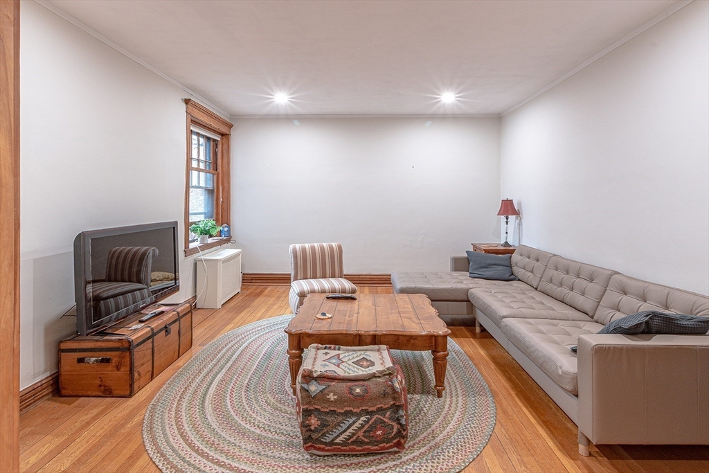 50 St Paul Street, Unit 4 Brookline, MA 02446 - Photo 3 of 21 a living room with furniture and a wooden floor