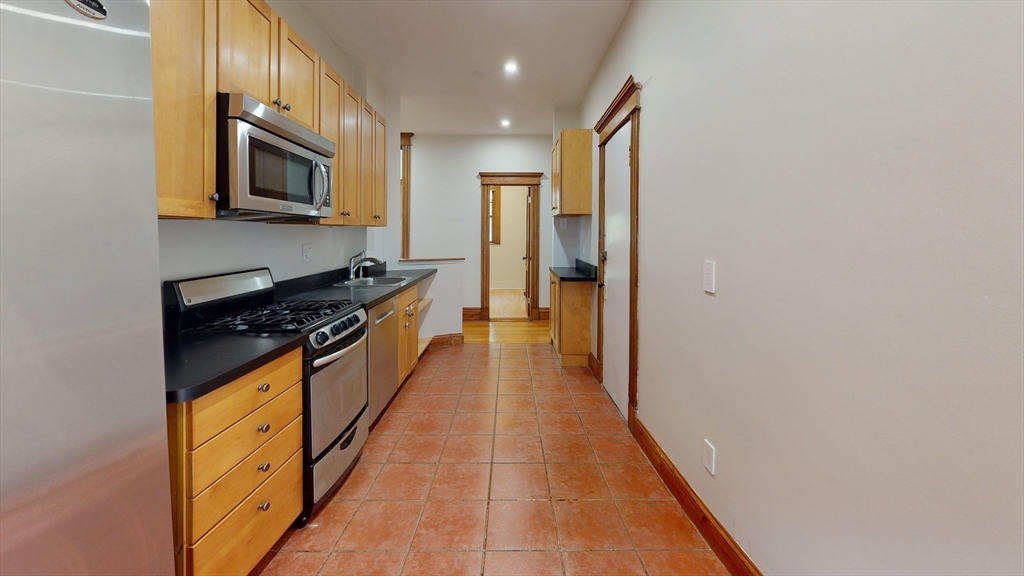 50 St Paul Street, Unit 4 Brookline, MA 02446 - Photo 4 of 21 a hallway with stainless steel appliances a stove top oven a sink and dishwasher
