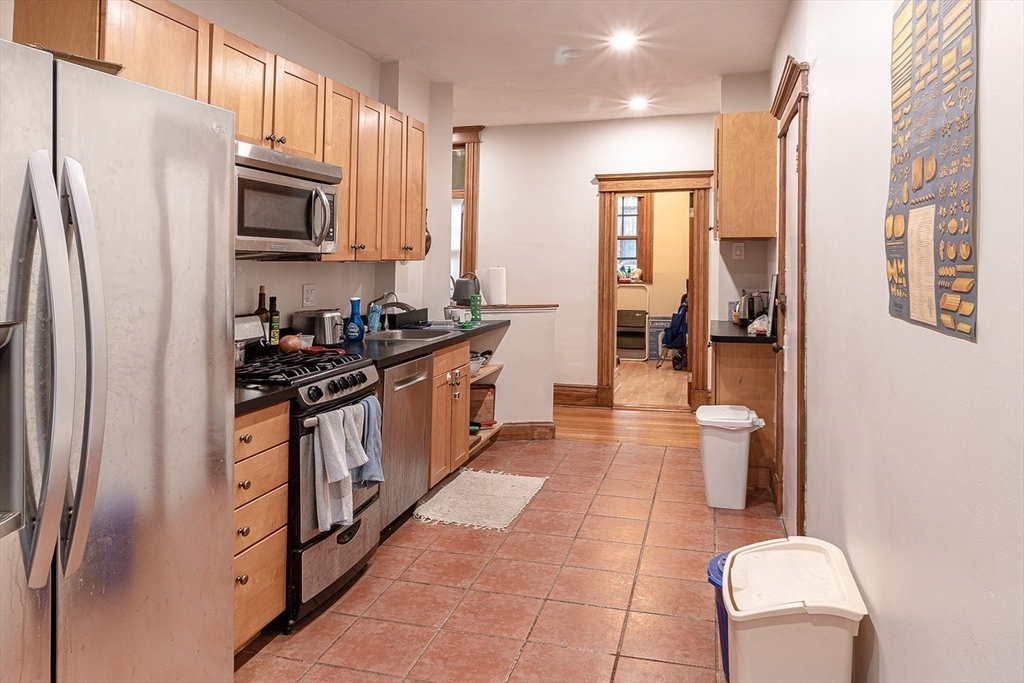 50 St Paul Street, Unit 4 Brookline, MA 02446 - Photo 5 of 21 a kitchen with stainless steel appliances granite countertop a refrigerator a stove top oven and a sink