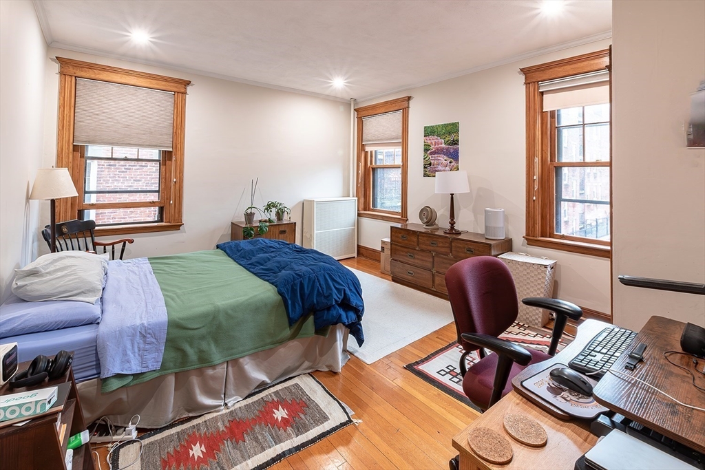 50 St Paul Street, Unit 4 Brookline, MA 02446 - Photo 9 of 21 a bedroom with a bed wooden floor and a window