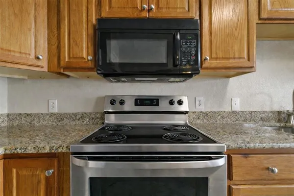 a stove top oven sitting inside of a kitchen