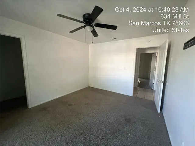 a view of a livingroom with a ceiling fan and wooden floor