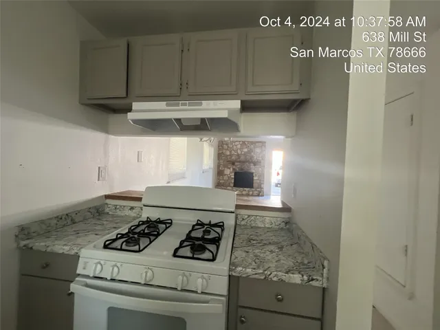 a stove top oven sitting inside of a kitchen