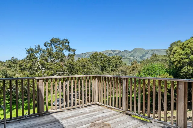 a balcony with wooden floor and fence