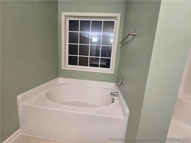 a white bath tub sitting next to a window
