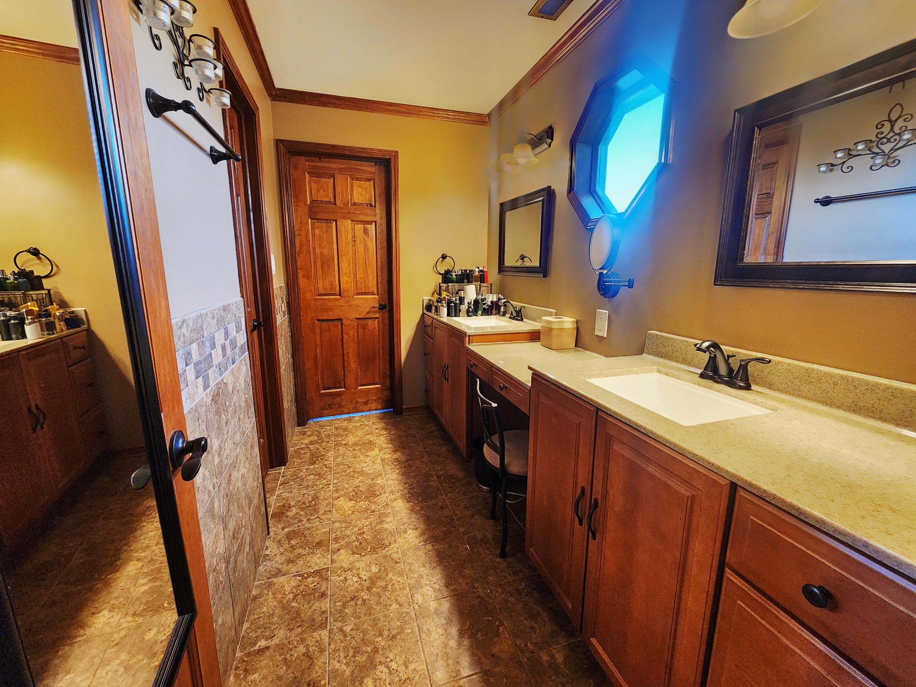 1407 Tyler Court Crown Point, IN 46307 - Photo 16 of 24 a spacious bathroom with a double vanity sink and a mirror