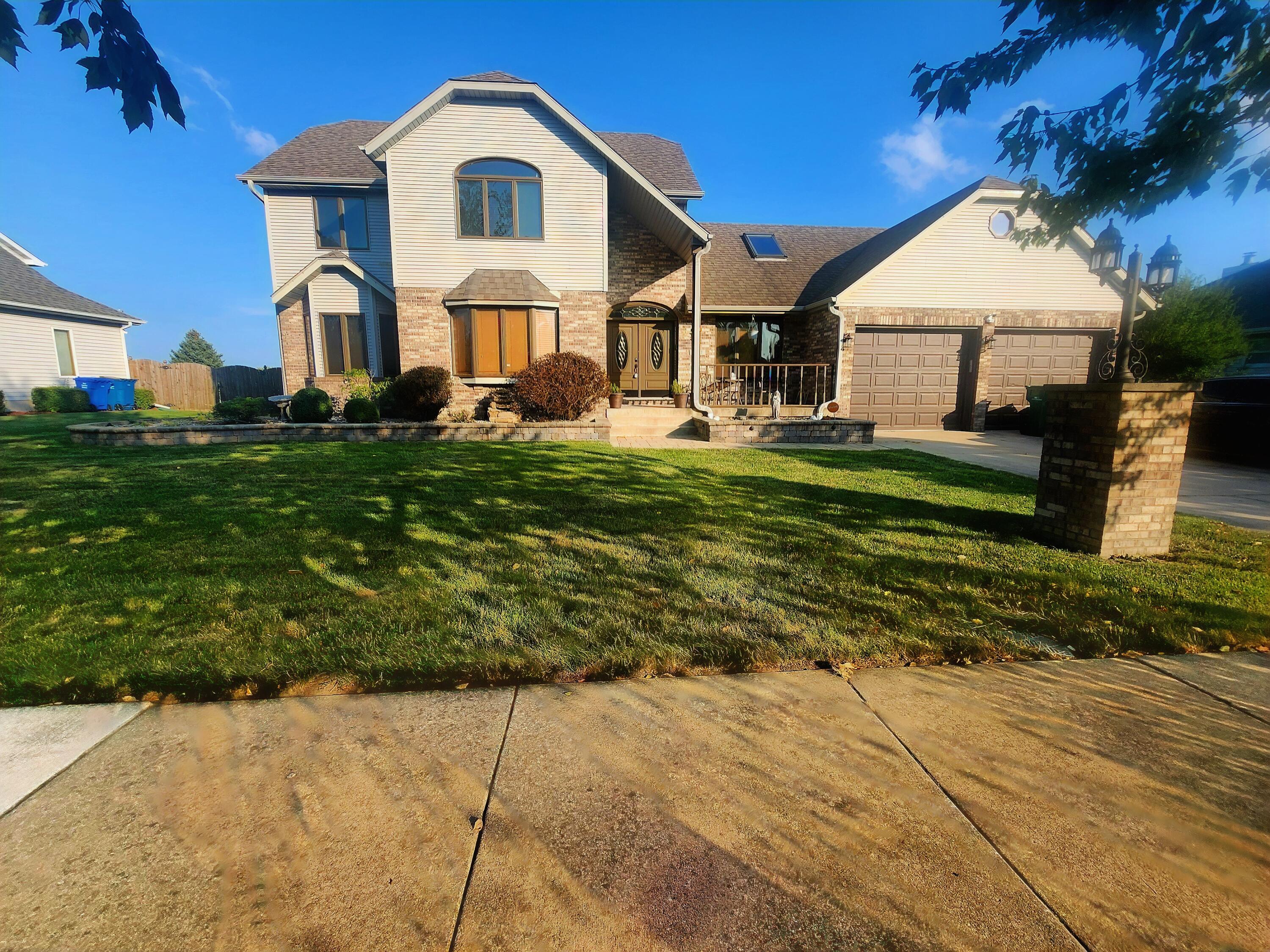 1407 Tyler Court Crown Point, IN 46307 - Photo 2 of 24 a front view of a house with a garden