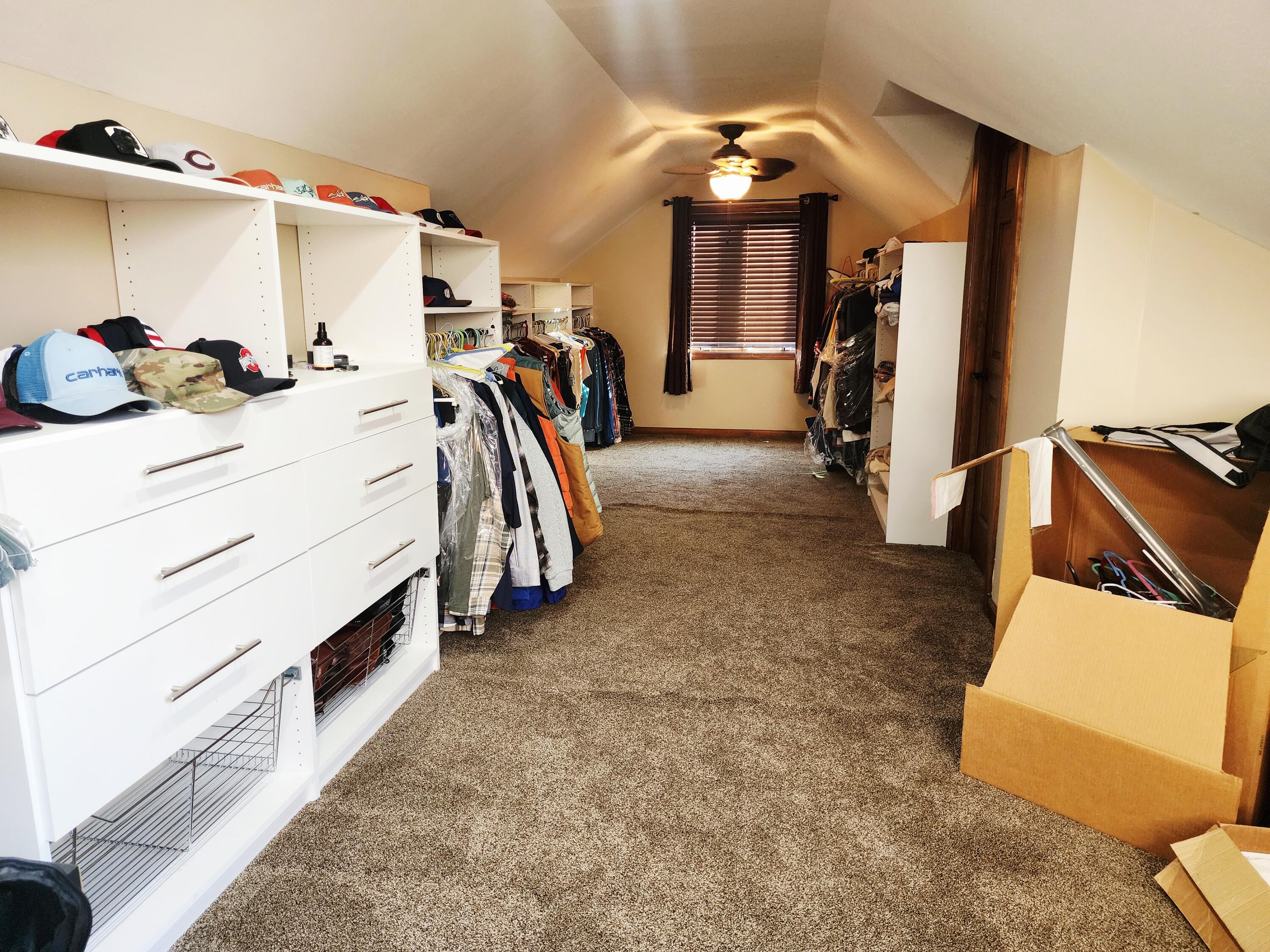 1407 Tyler Court Crown Point, IN 46307 - Photo 21 of 24 a view of walk in closet with clothes and shoes