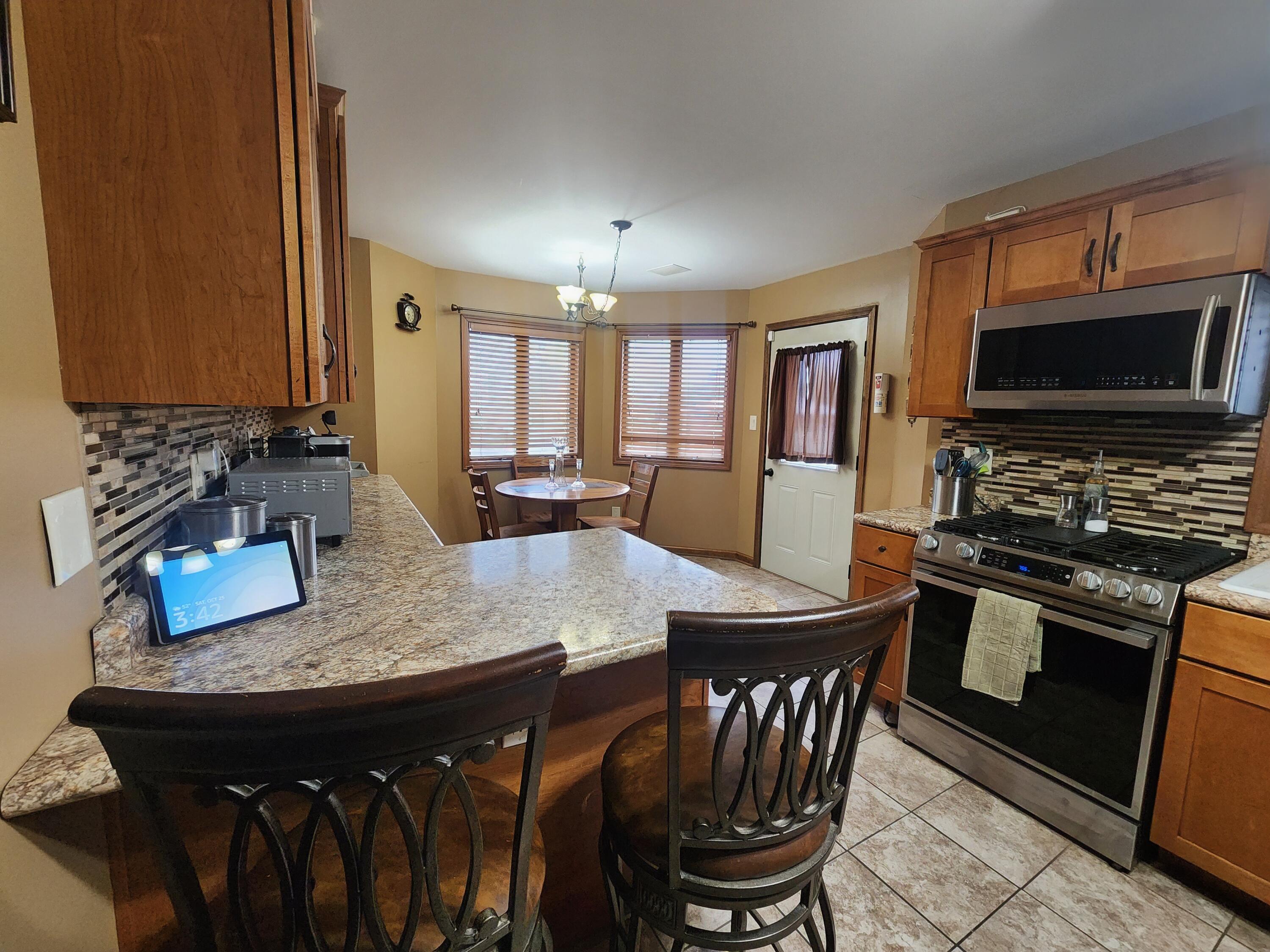 1407 Tyler Court Crown Point, IN 46307 - Photo 7 of 24 a kitchen with a stove a sink and a refrigerator