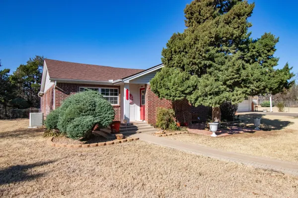 a view of the house with a yard