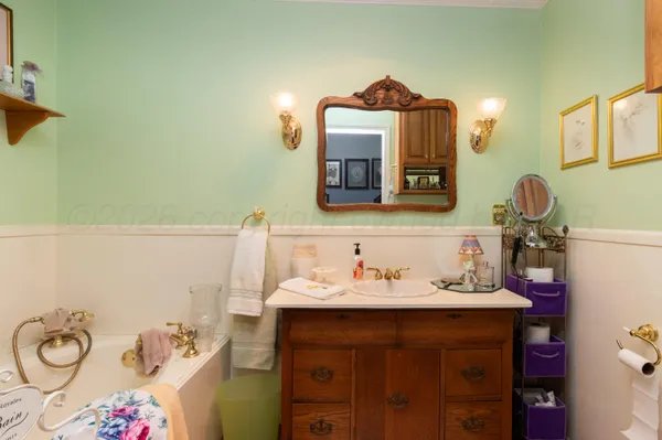 a bathroom with a sink mirror and vanity