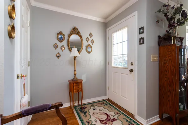 a view of an entryway with wooden floor