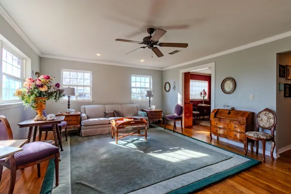 a living room with furniture and a chandelier