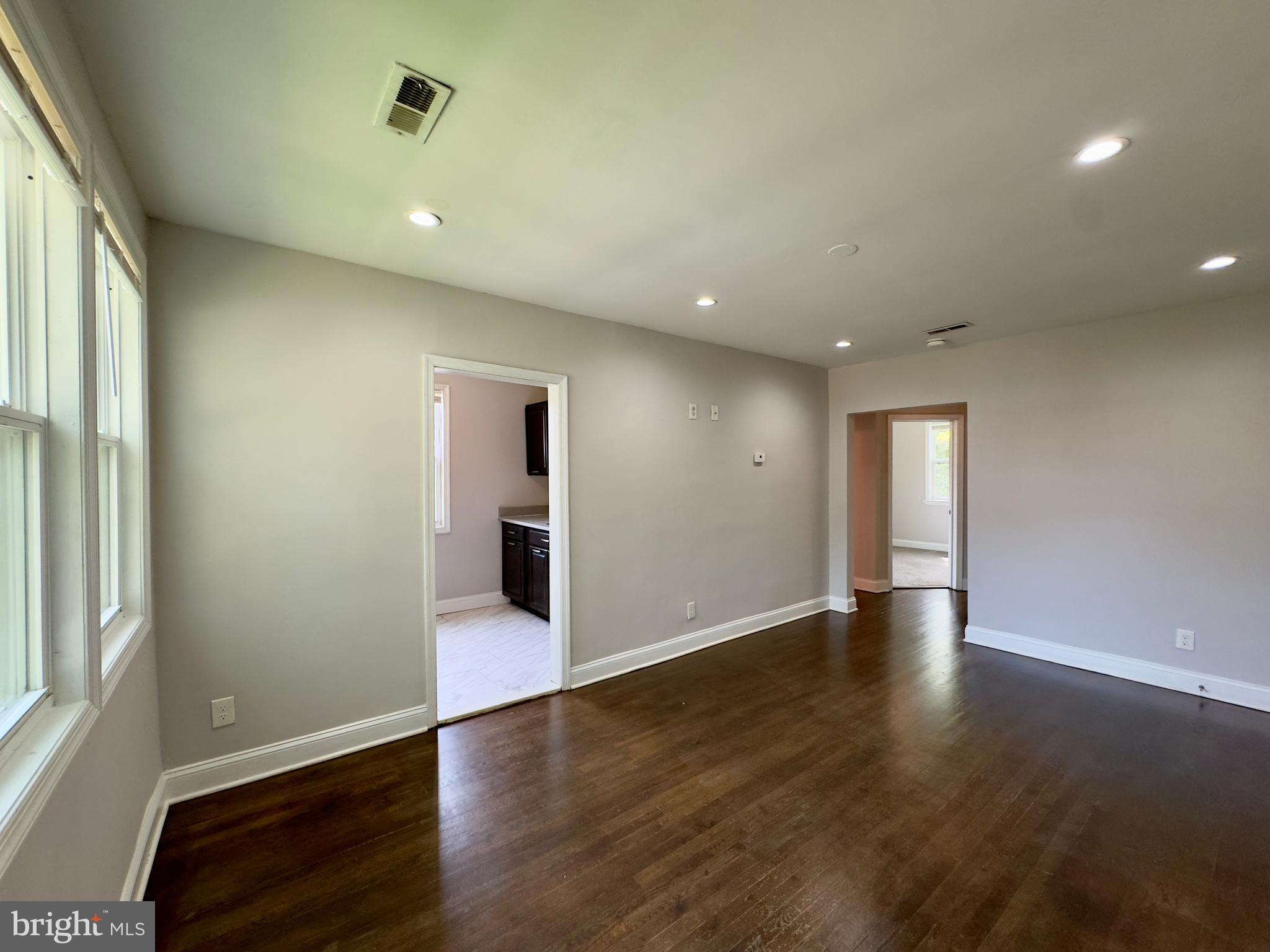 1111 Gleneagle Road, Unit 2 Baltimore, MD 21239 - Photo 3 of 11 an empty room with wooden floor and windows
