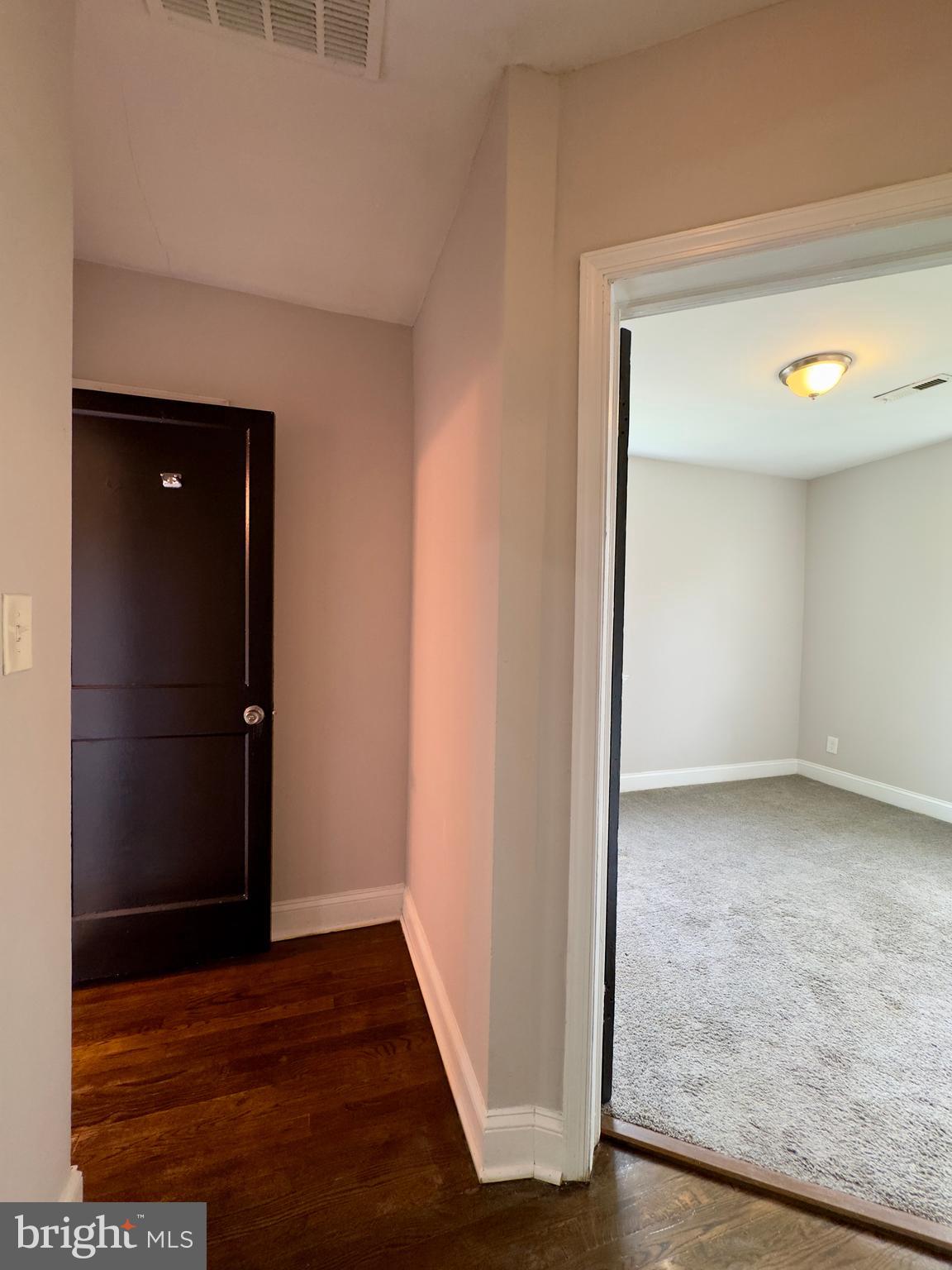 1111 Gleneagle Road, Unit 2 Baltimore, MD 21239 - Photo 7 of 11 a view of an empty room with wooden floor and closet