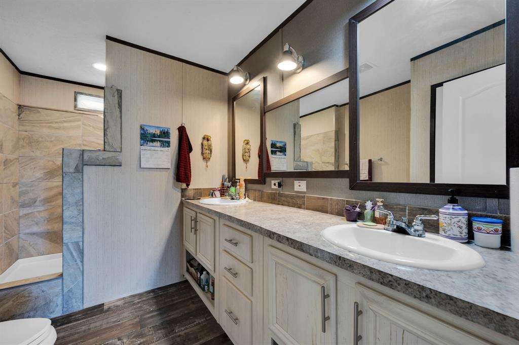 12032 County Road 0190 Rice, TX 75155 - Photo 14 of 40 a bathroom with a double vanity sink and mirror