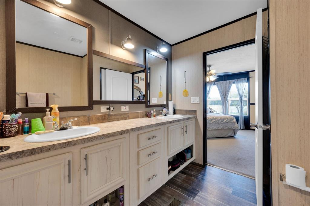 12032 County Road 0190 Rice, TX 75155 - Photo 15 of 40 a bathroom with a double vanity sink and a mirror